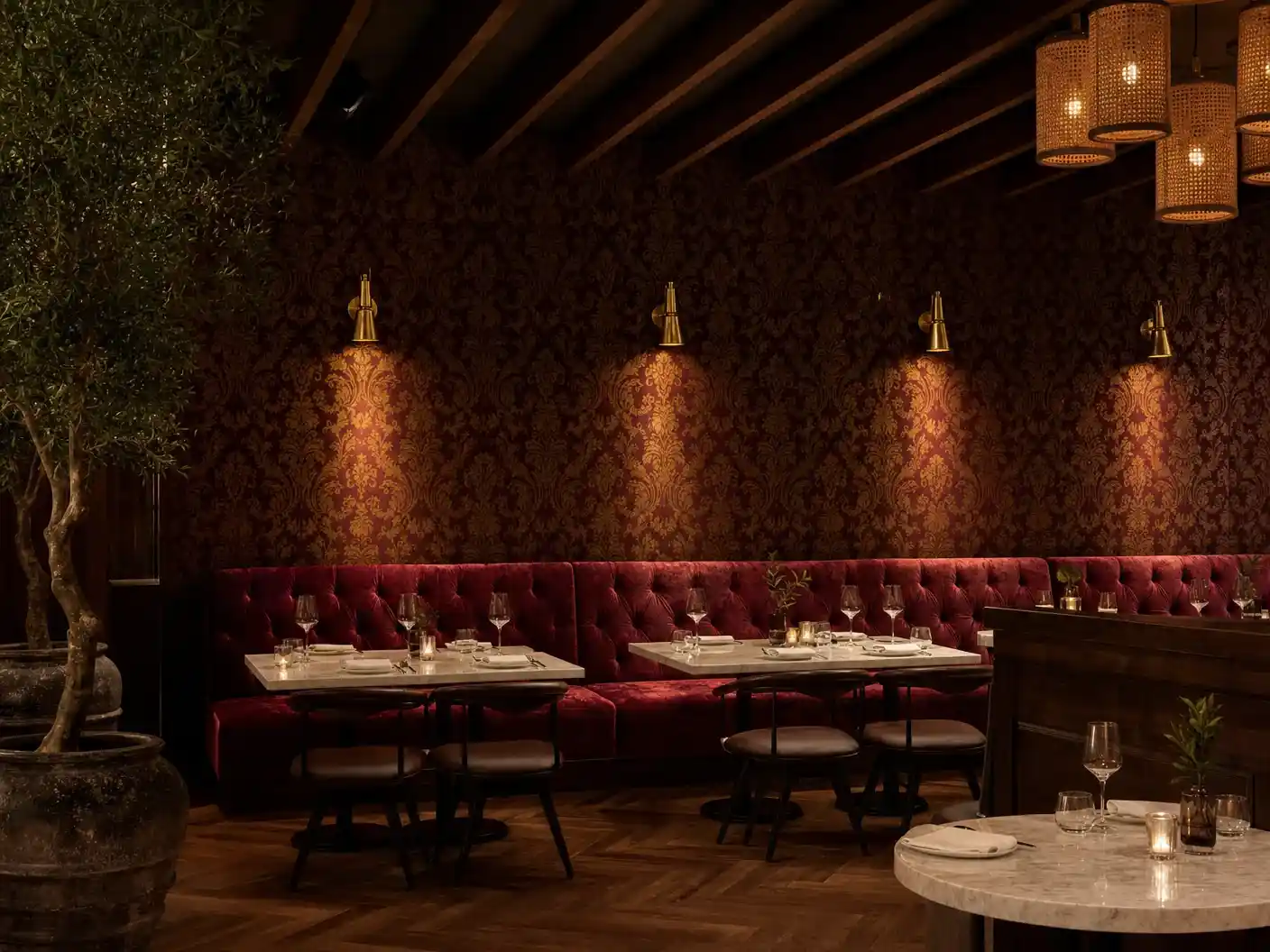 Philadelphia restaurant with oxblood damask wallpaper above velvet banquette